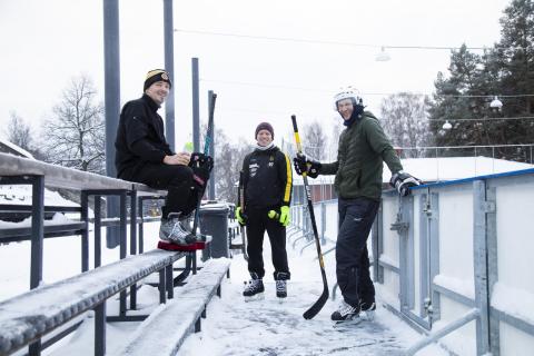 Three hockey players at Koulukatu ice rink.
