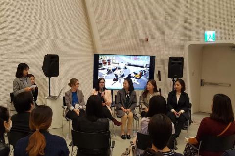 A group of people giving a presentation in front of an audience.