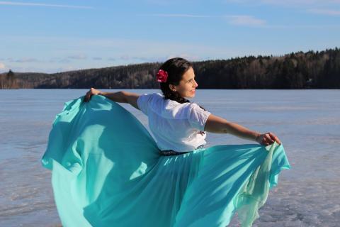 A person dancing on the ice of a lake.
