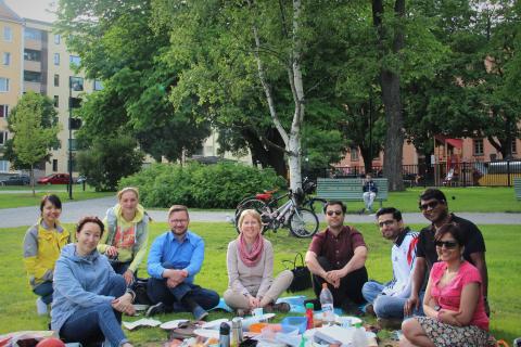 Group of people having a picnic in a park.