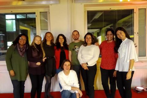 Group of people smiling and posing together.